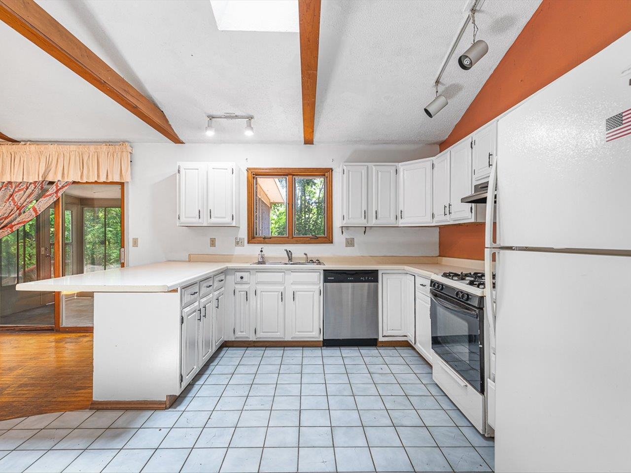 3621 Baxter Road Rockford, IL 61109 - Photo 6 of 56 a kitchen with a sink a stove top oven and white cabinets