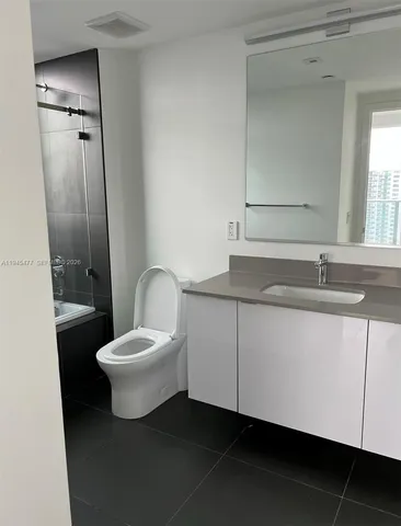 a bathroom with a toilet sink and shower