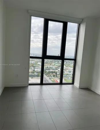 a view of an empty room with a window