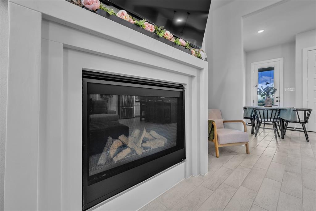 2004 Willy Dilly Road Springtown, TX 76082 - Photo 12 of 40 White-trimmed fireplace with a glass-front insert and log media