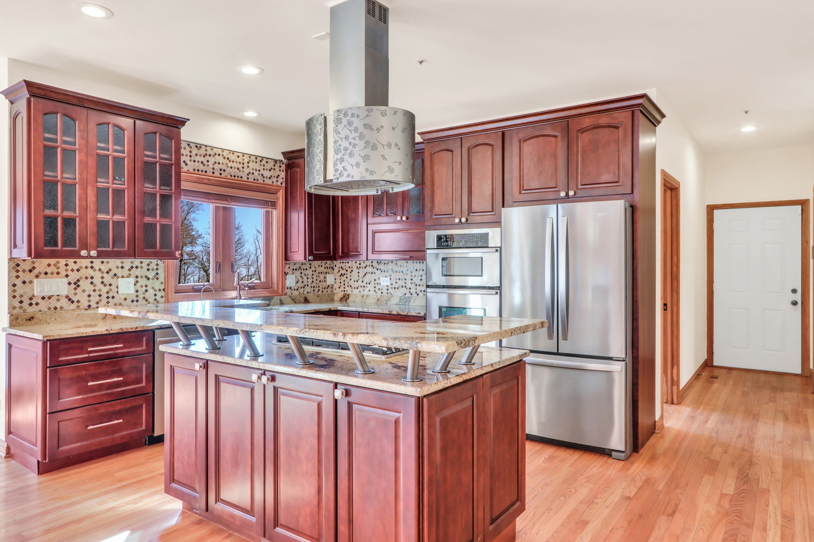 6881 September Boulevard Long Grove, IL 60047 - Photo 16 of 64 a kitchen with stainless steel appliances granite countertop a refrigerator a stove and a sink with wooden floor
