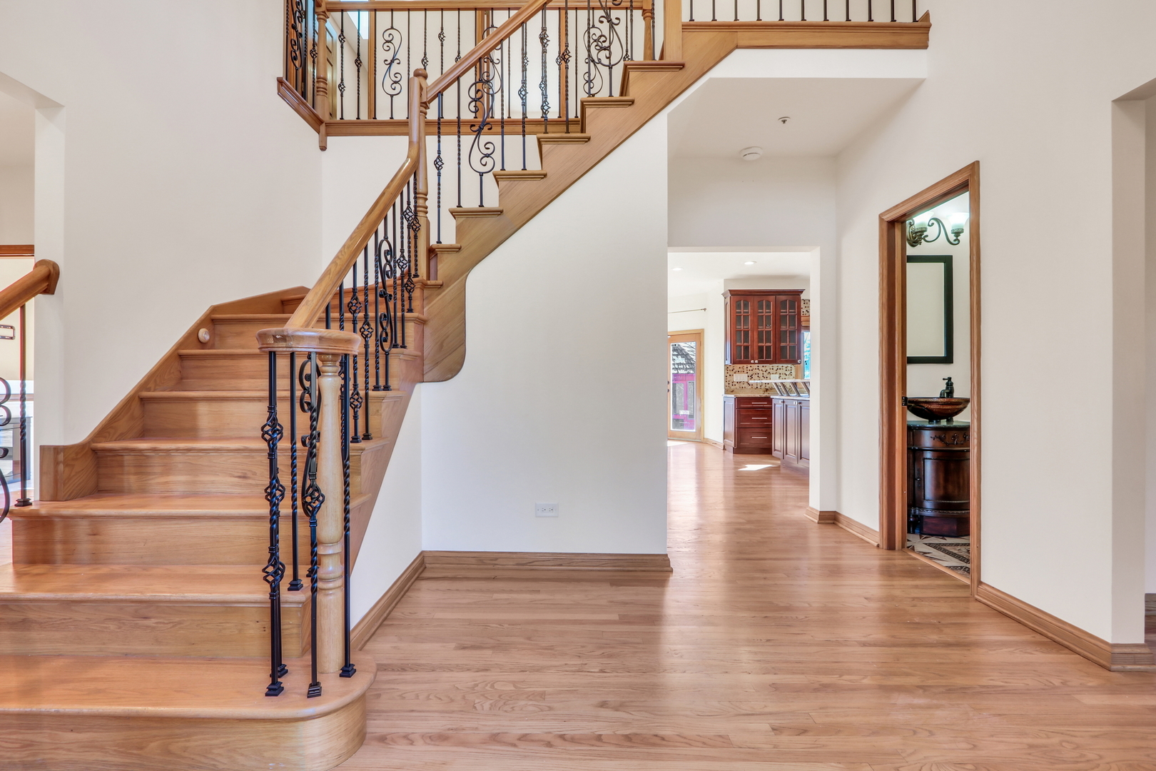6881 September Boulevard Long Grove, IL 60047 - Photo 2 of 64 a view of staircase with lots of frames on wall and wooden floor