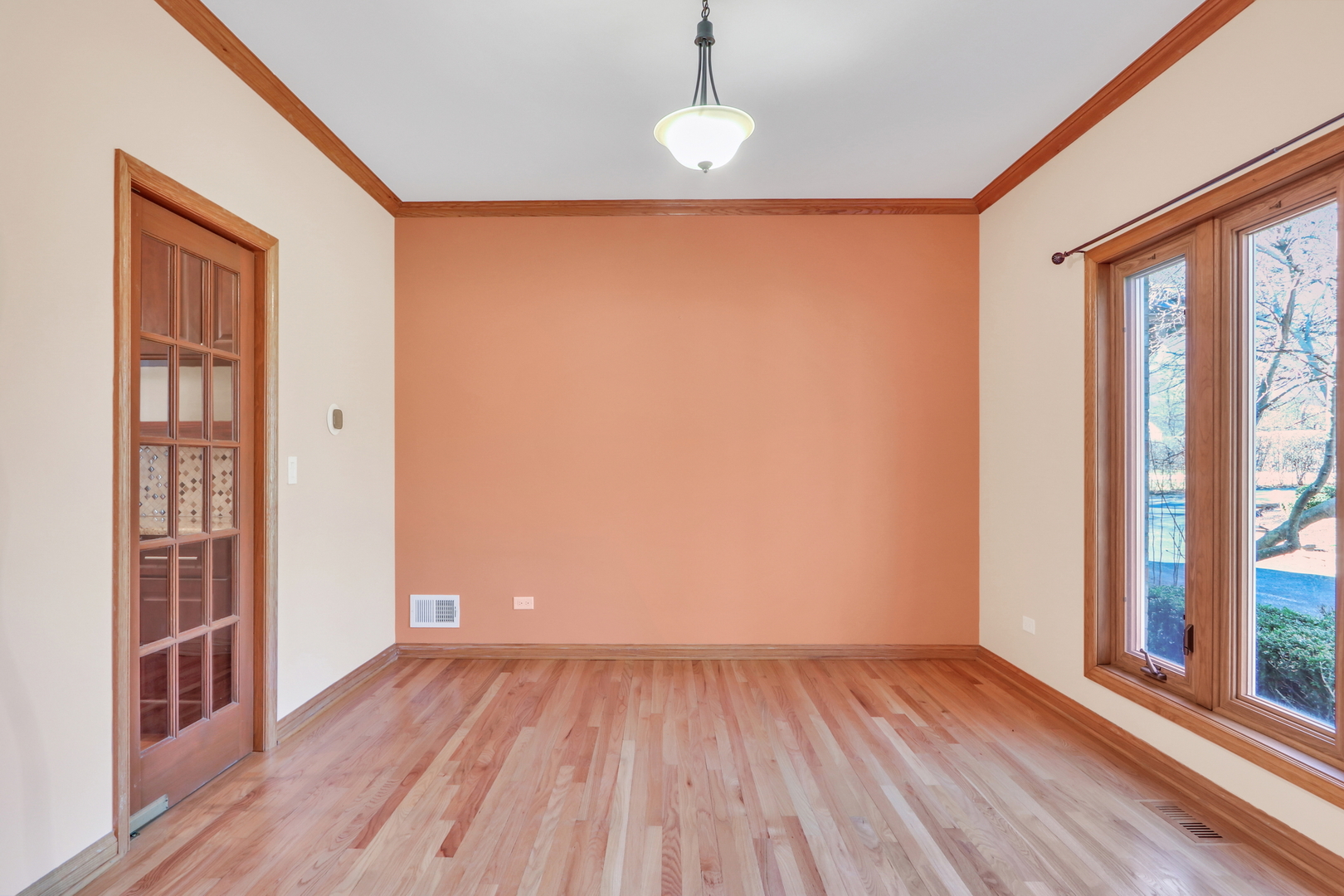 6881 September Boulevard Long Grove, IL 60047 - Photo 23 of 64 a view of an empty room with wooden floor and a window