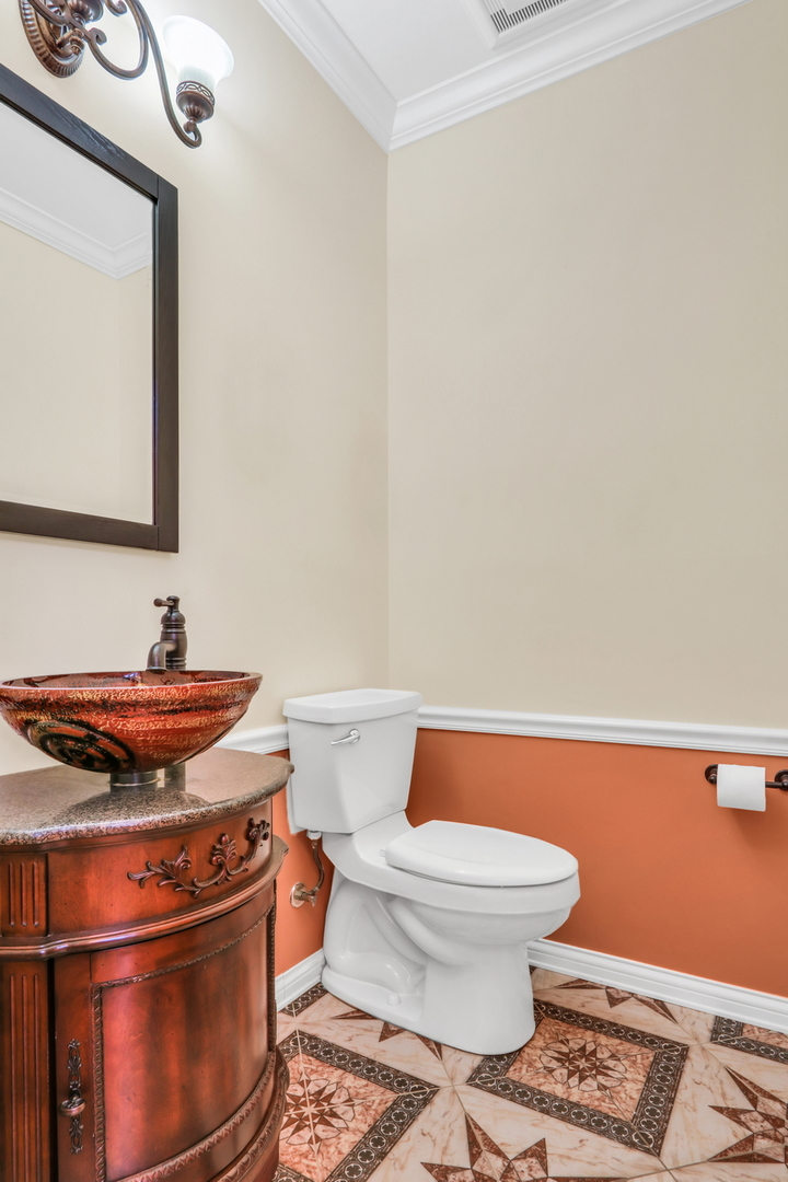 6881 September Boulevard Long Grove, IL 60047 - Photo 24 of 64 a bathroom with a granite countertop toilet and a sink