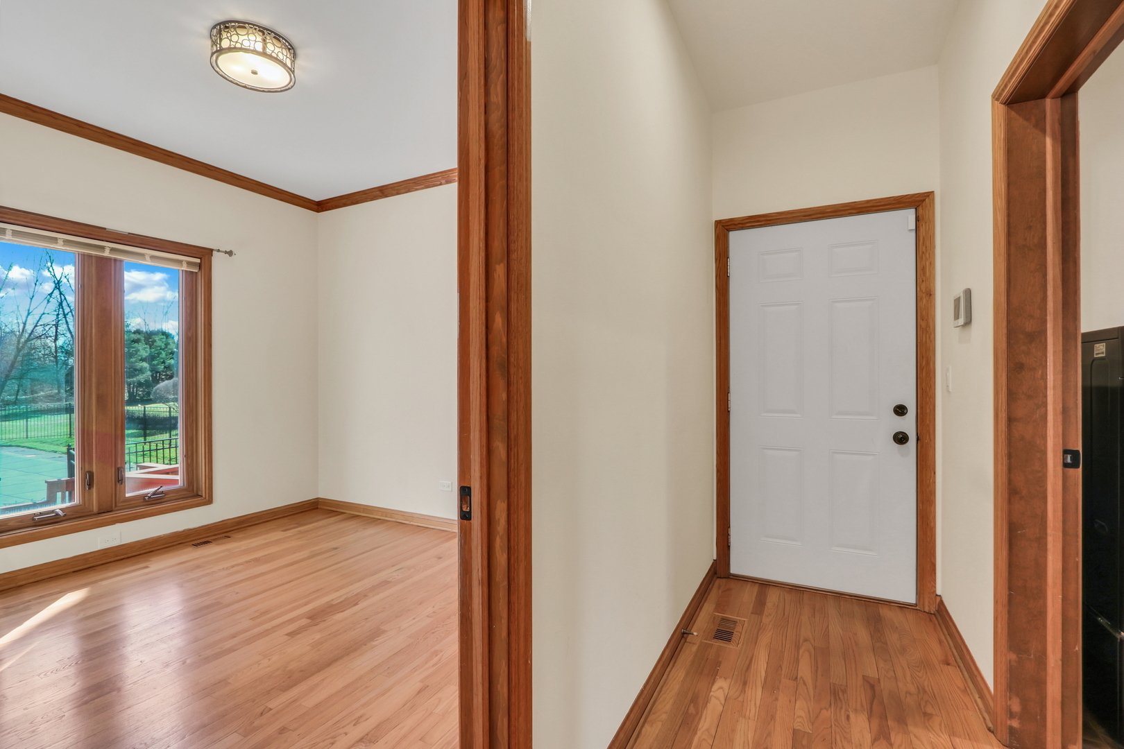 6881 September Boulevard Long Grove, IL 60047 - Photo 25 of 64 a view of an empty room with wooden floor and a window