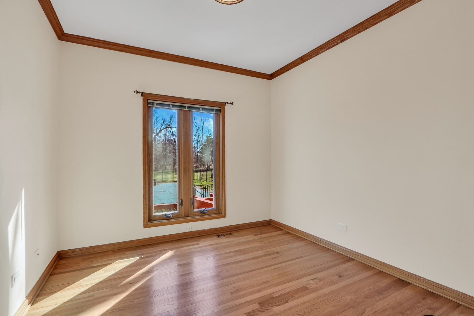 6881 September Boulevard Long Grove, IL 60047 - Photo 26 of 64 a view of an empty room with wooden floor and a window