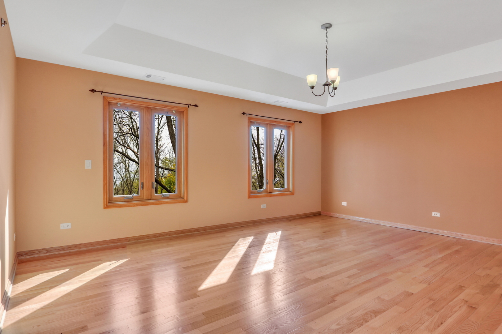 6881 September Boulevard Long Grove, IL 60047 - Photo 29 of 64 a view of livingroom with window chandelier fan and wooden floor