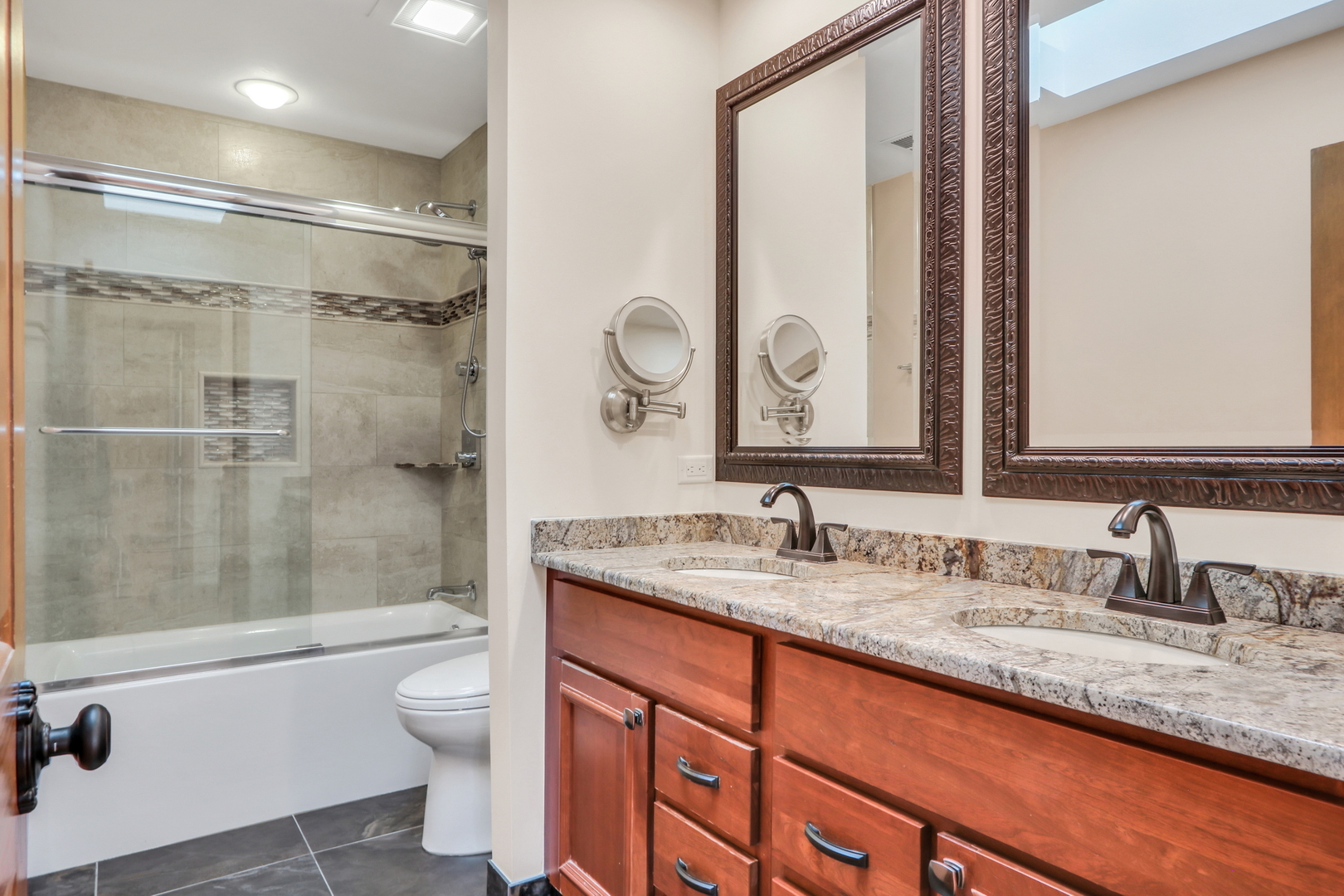 6881 September Boulevard Long Grove, IL 60047 - Photo 39 of 64 a bathroom with a granite countertop sink toilet mirror and shower