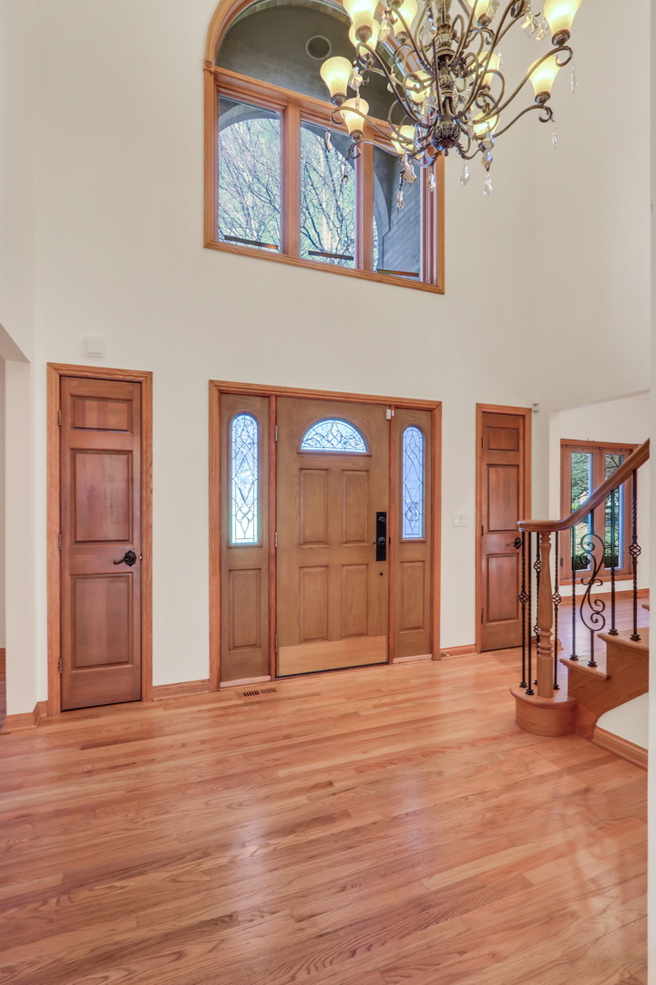 6881 September Boulevard Long Grove, IL 60047 - Photo 4 of 64 a view of a livingroom with a furniture wooden floor and a chandelier