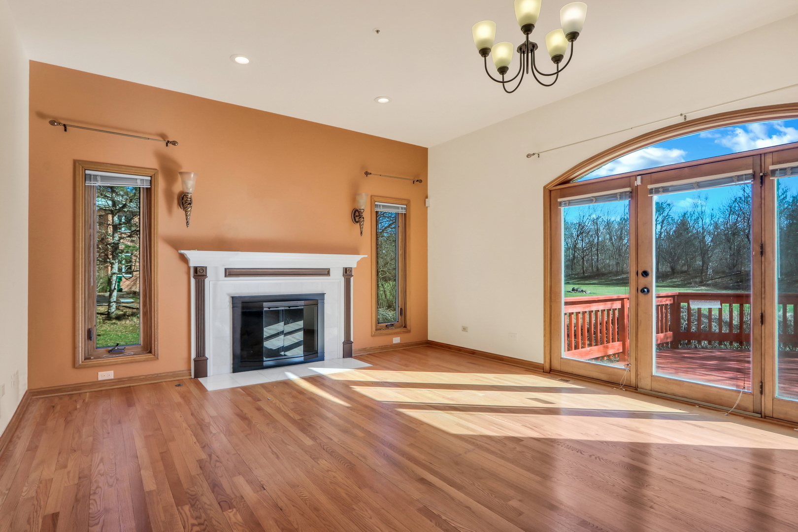6881 September Boulevard Long Grove, IL 60047 - Photo 8 of 64 a view of an empty room with wooden floor fireplace and a window