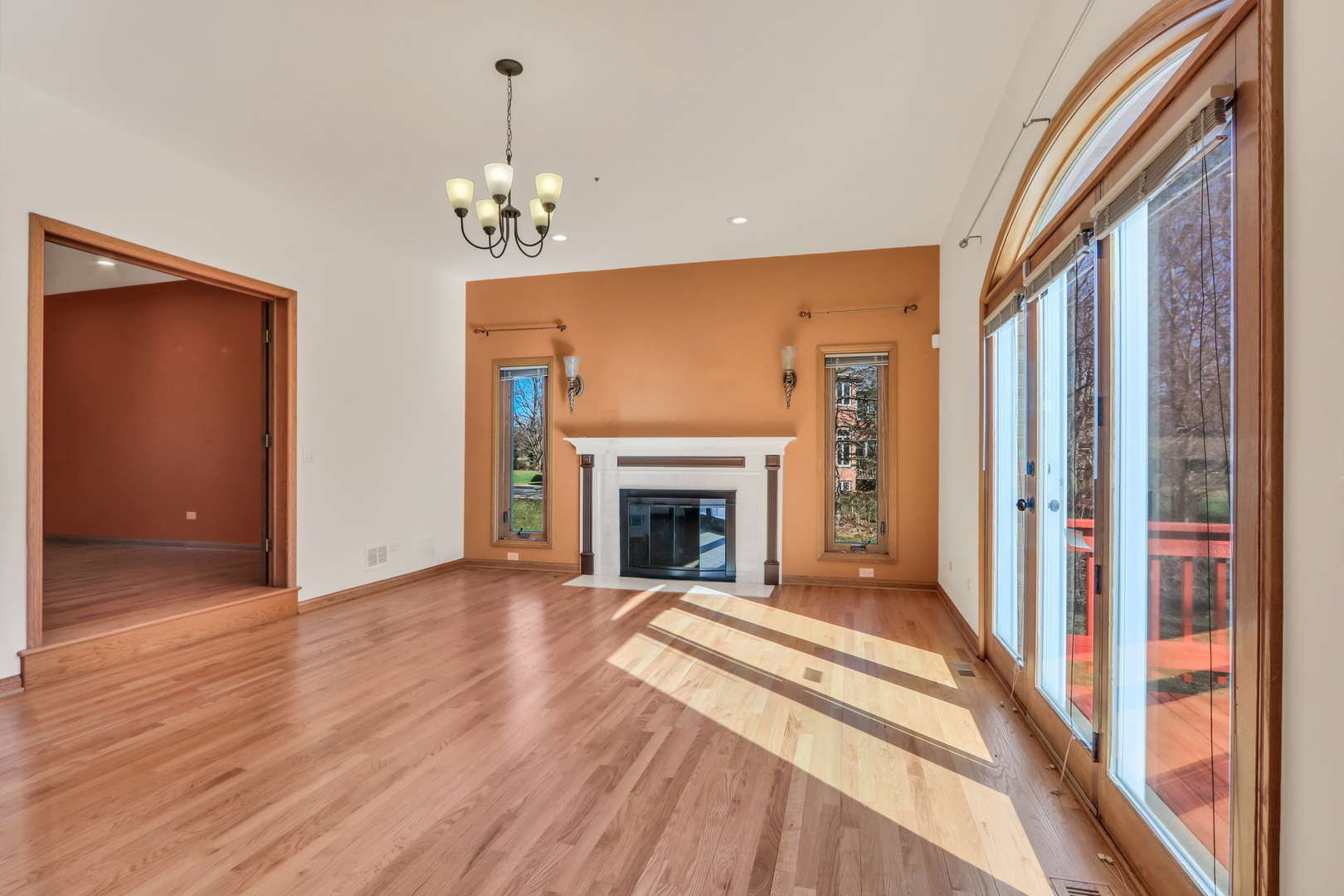 6881 September Boulevard Long Grove, IL 60047 - Photo 9 of 64 a view of a livingroom with a fireplace wooden floor and chandelier