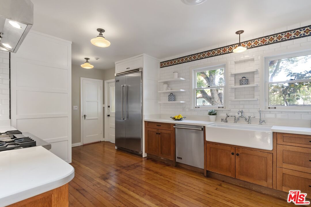 2303 Midvale Avenue Los Angeles, CA 90064 - Photo 13 of 38 a large kitchen with stainless steel appliances a lot of counter space and wooden floor