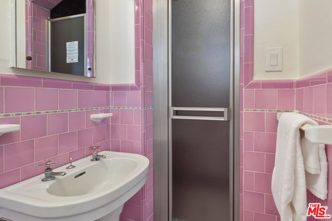 2303 Midvale Avenue Los Angeles, CA 90064 - Photo 19 of 38 a bathroom with a sink and a mirror
