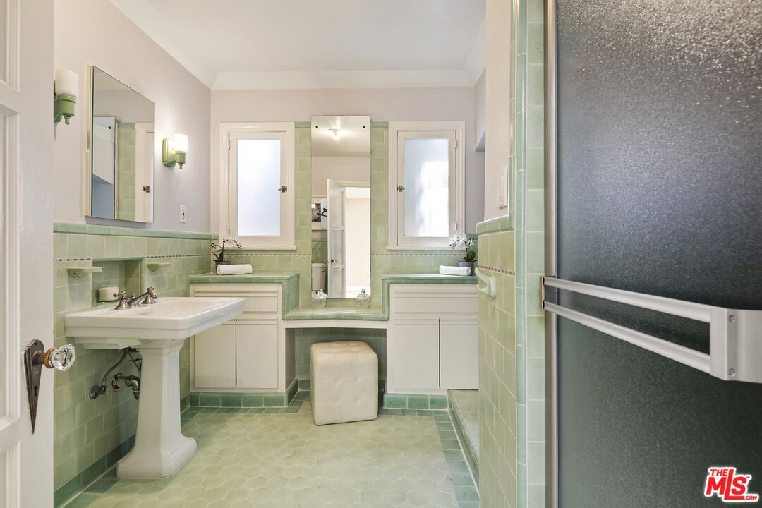 2303 Midvale Avenue Los Angeles, CA 90064 - Photo 25 of 38 a bathroom with a sink a toilet and a mirror