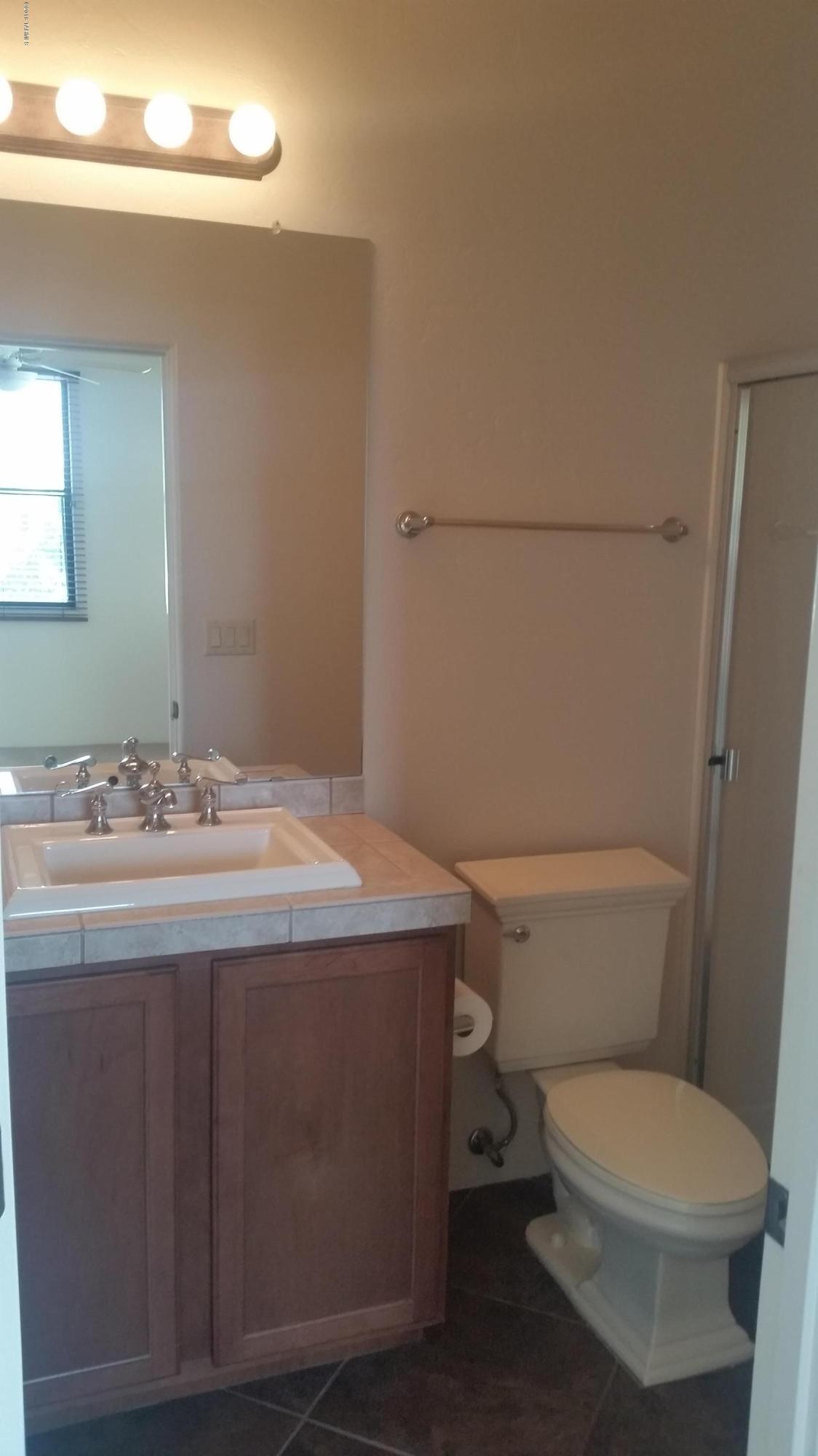 478 East Cedarvale Road Tucson, AZ 85704 - Photo 31 of 39 a bathroom with a granite countertop toilet and a sink