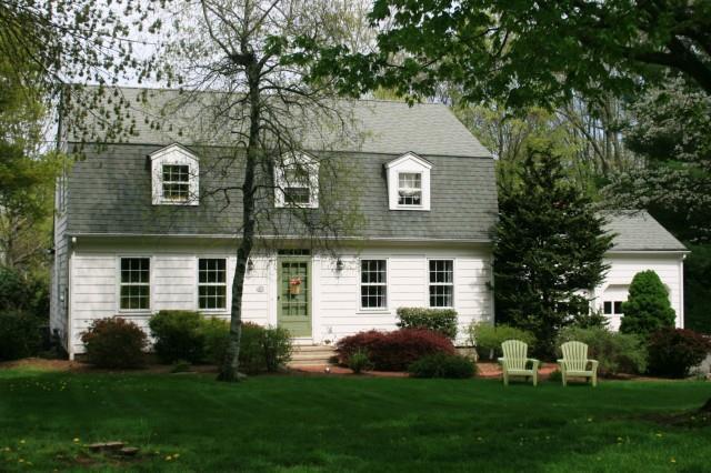 408 Mountain Laurel Road Fairfield, CT 06824 - Photo 1 of 1 a front view of a house with a garden and yard