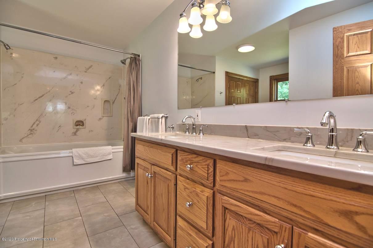 353 Ridge Road Wyoming, PA 18644 - Photo 38 of 157 a spacious bathroom with a granite countertop sink mirror and a bath tub