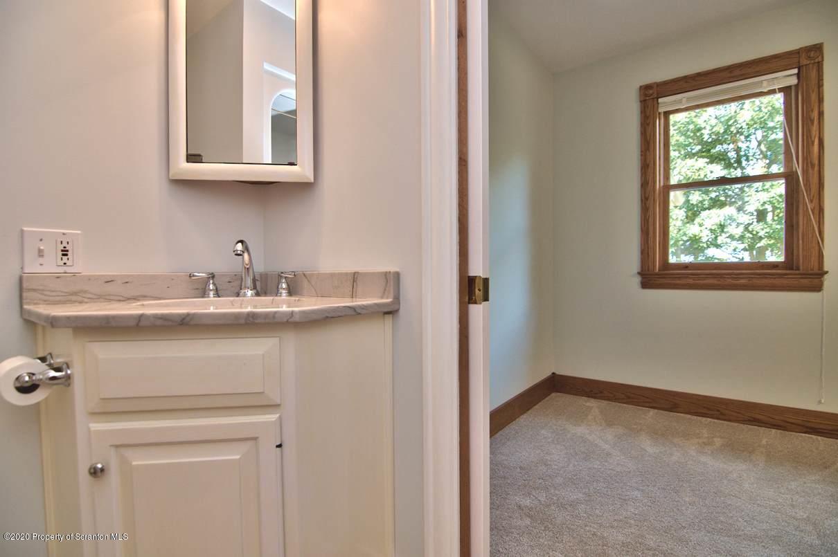 353 Ridge Road Wyoming, PA 18644 - Photo 65 of 157 a bathroom with a sink and a mirror