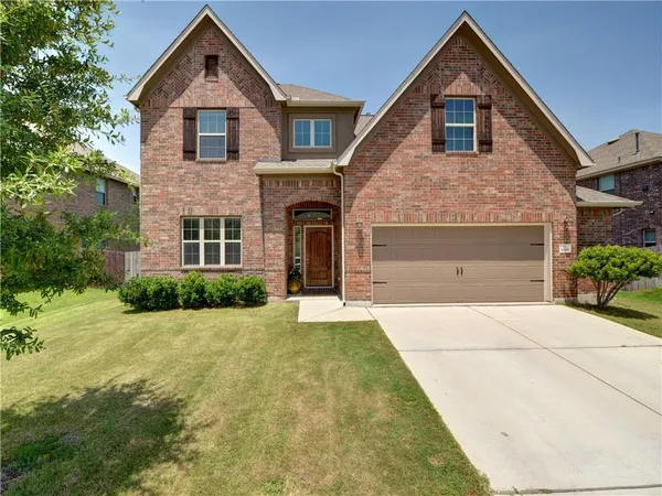 a front view of a house with a yard