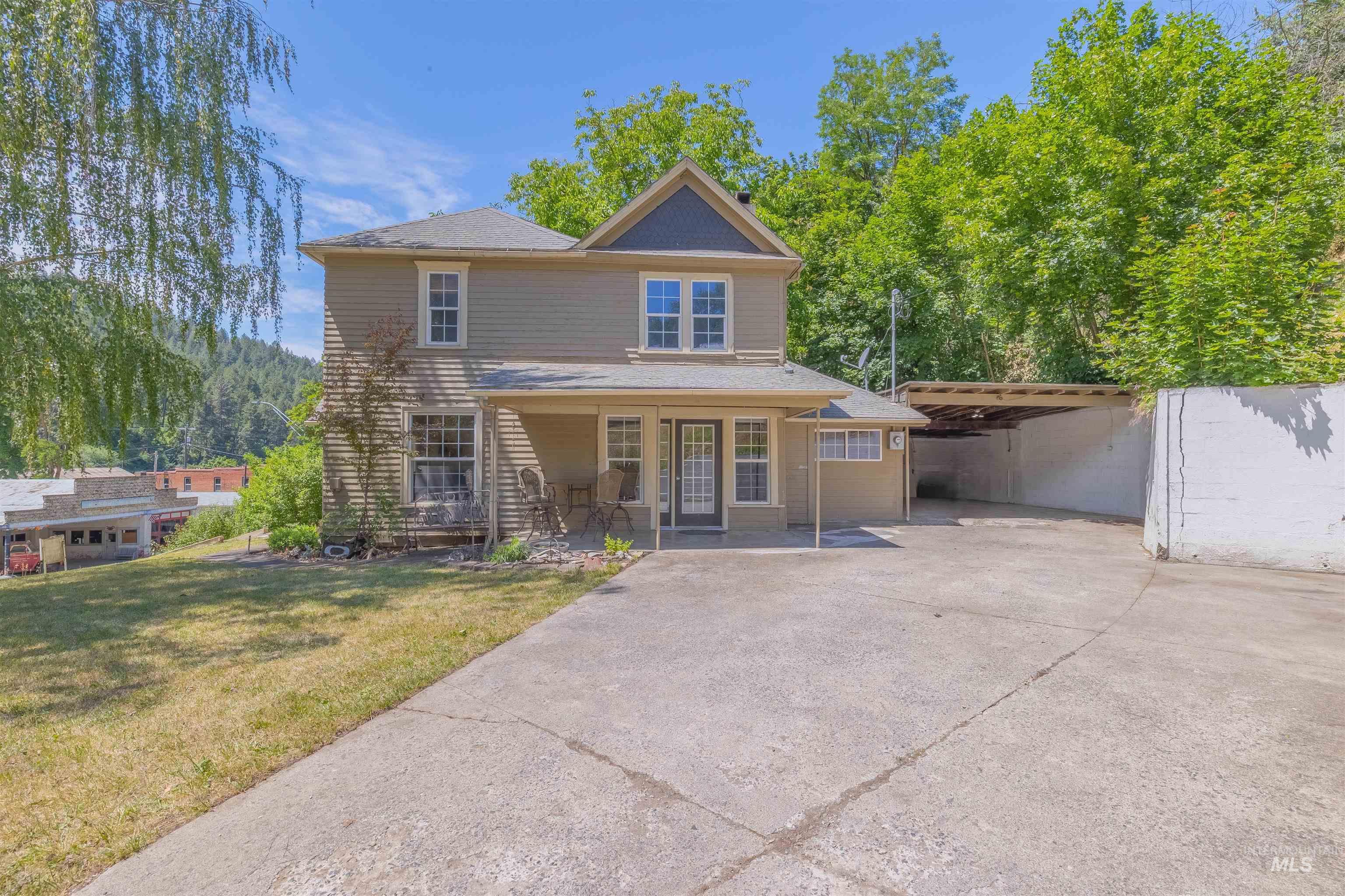 812 Main Street Kendrick, ID 83537 - Photo 22 of 30 View of front of home with a patio area, concrete driveway, a front lawn, and a carport