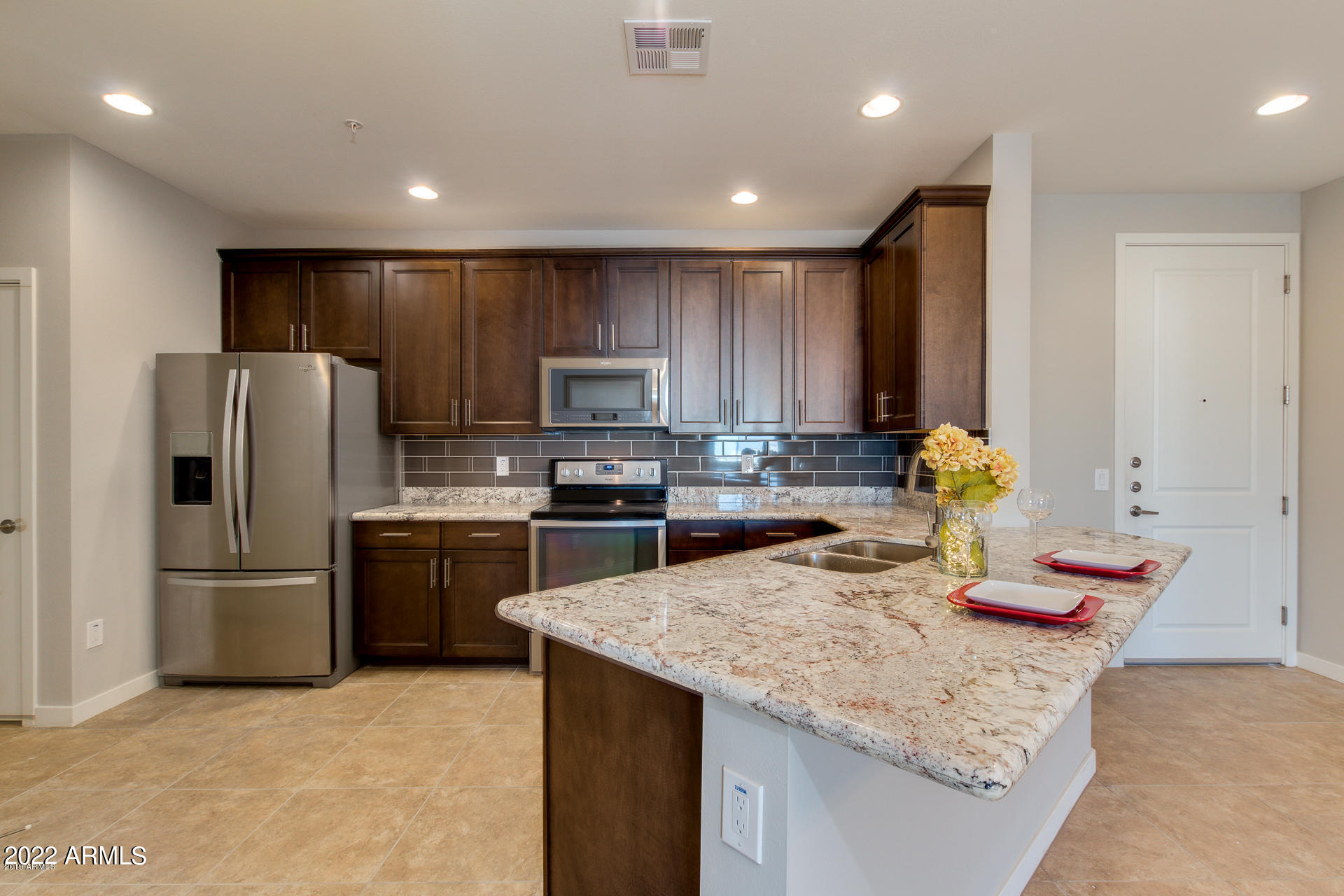 2511 West Queen Creek Road, Unit 238 Chandler, AZ 85248 - Photo 15 of 22 a kitchen with granite countertop stainless steel appliances and refrigerator