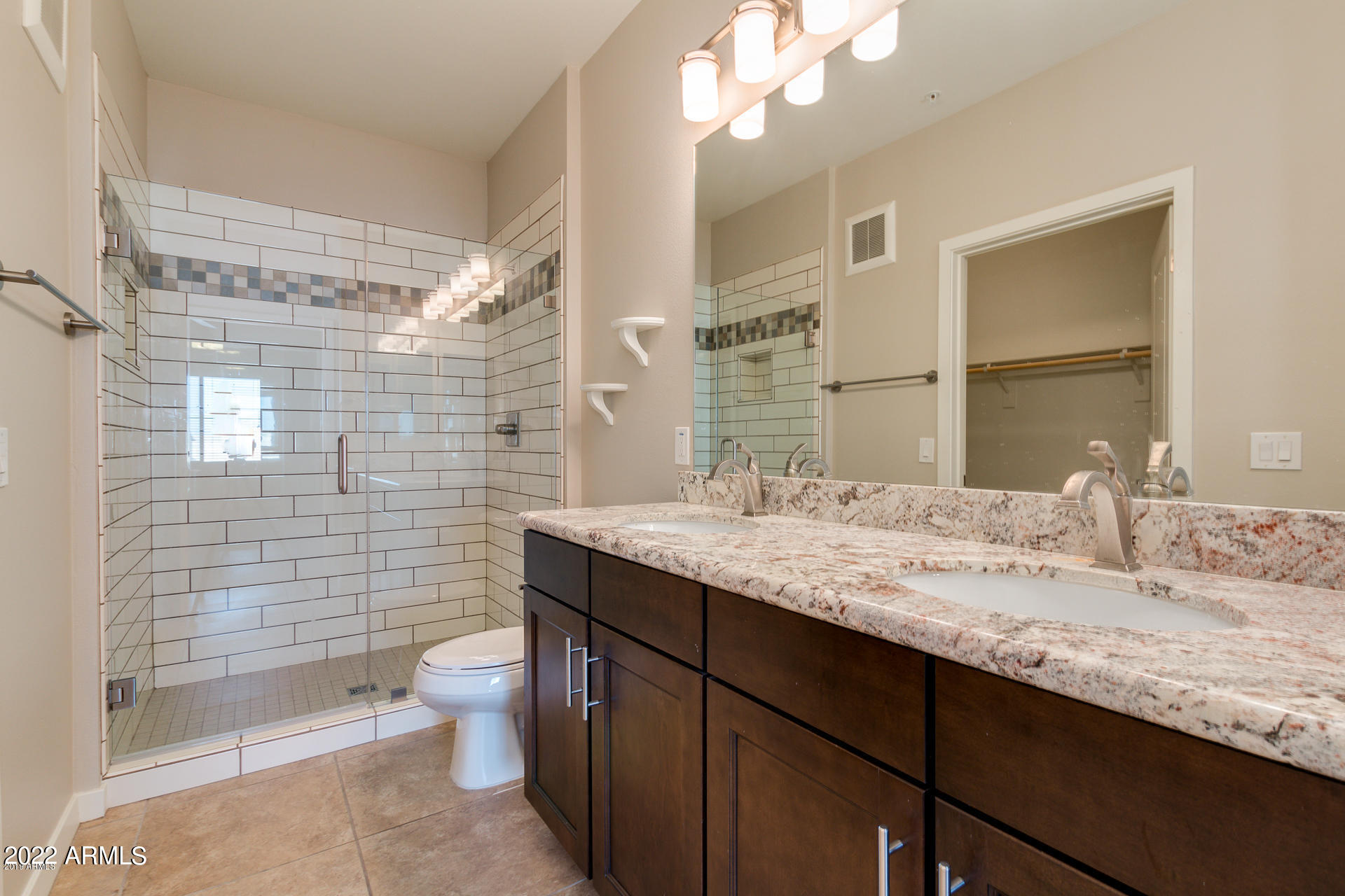 2511 West Queen Creek Road, Unit 238 Chandler, AZ 85248 - Photo 21 of 22 a bathroom with a granite countertop sink toilet and shower