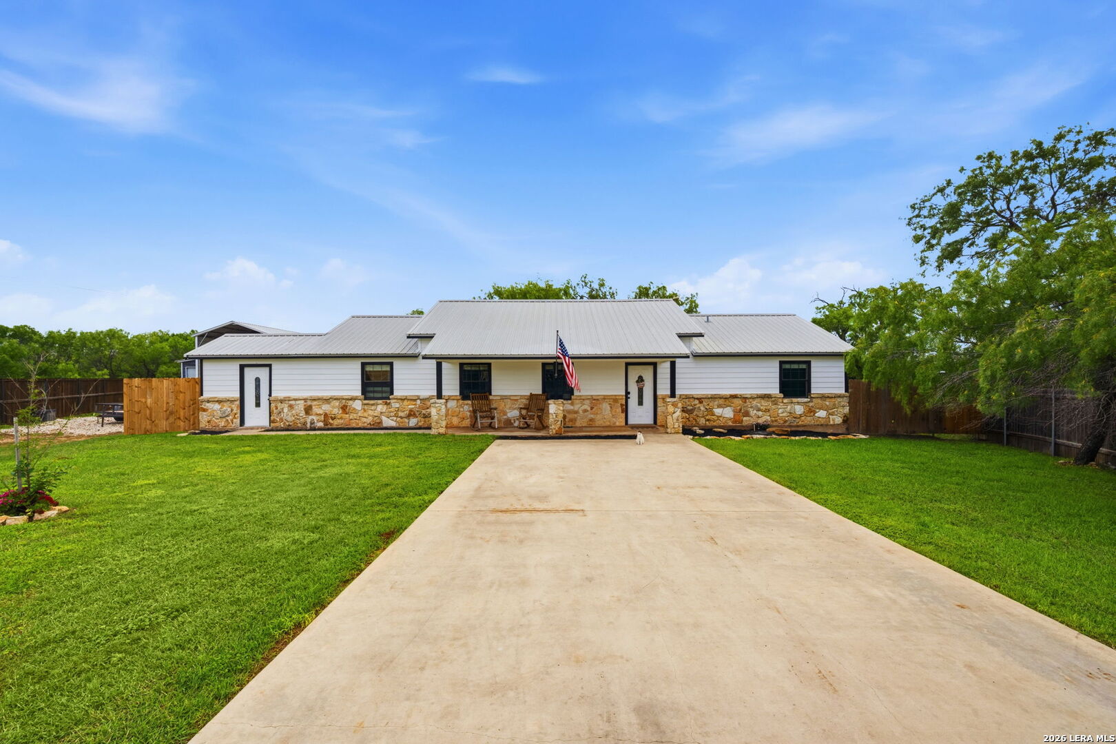 202 Bryan Drive Jourdanton, TX 78026 - Photo 1 of 28 a front view of a house with a garden