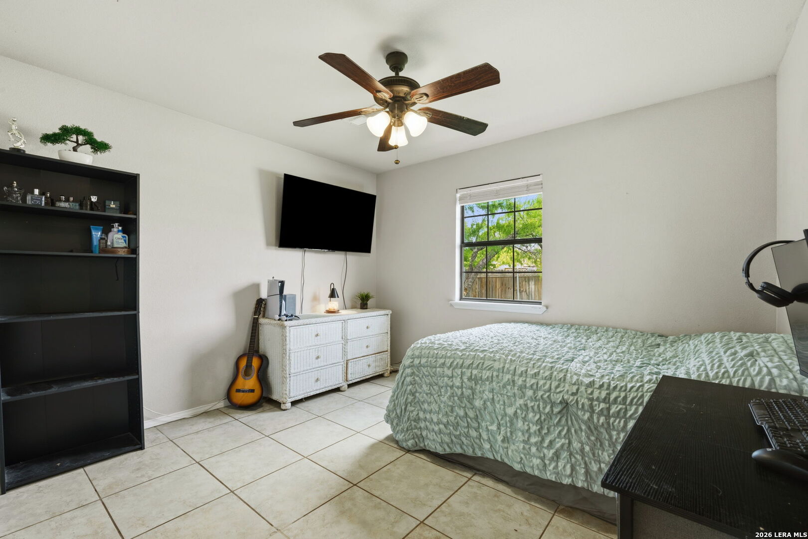 202 Bryan Drive Jourdanton, TX 78026 - Photo 17 of 28 a bedroom with a bed and a flat screen tv