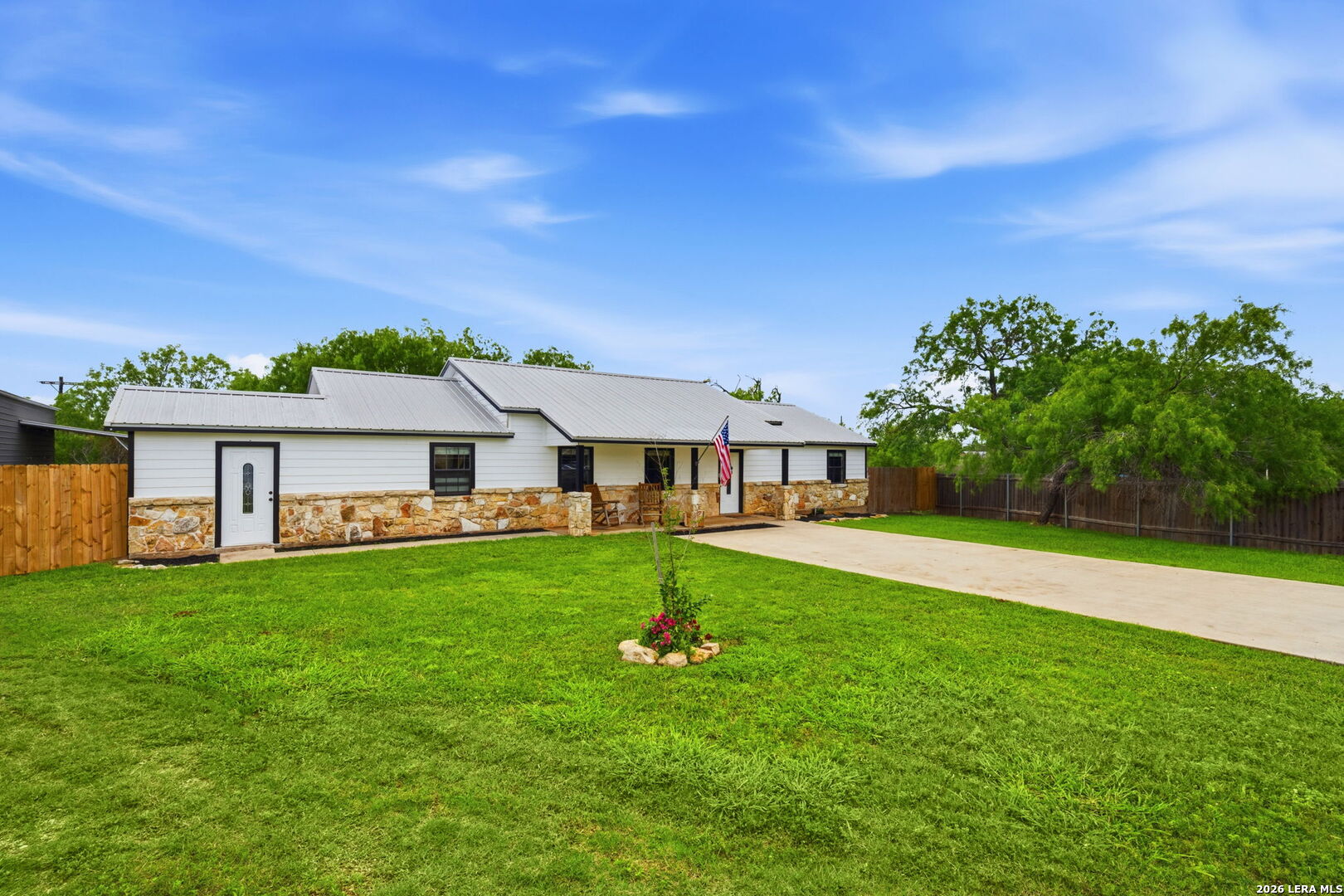 202 Bryan Drive Jourdanton, TX 78026 - Photo 2 of 28 a front view of a house with a garden