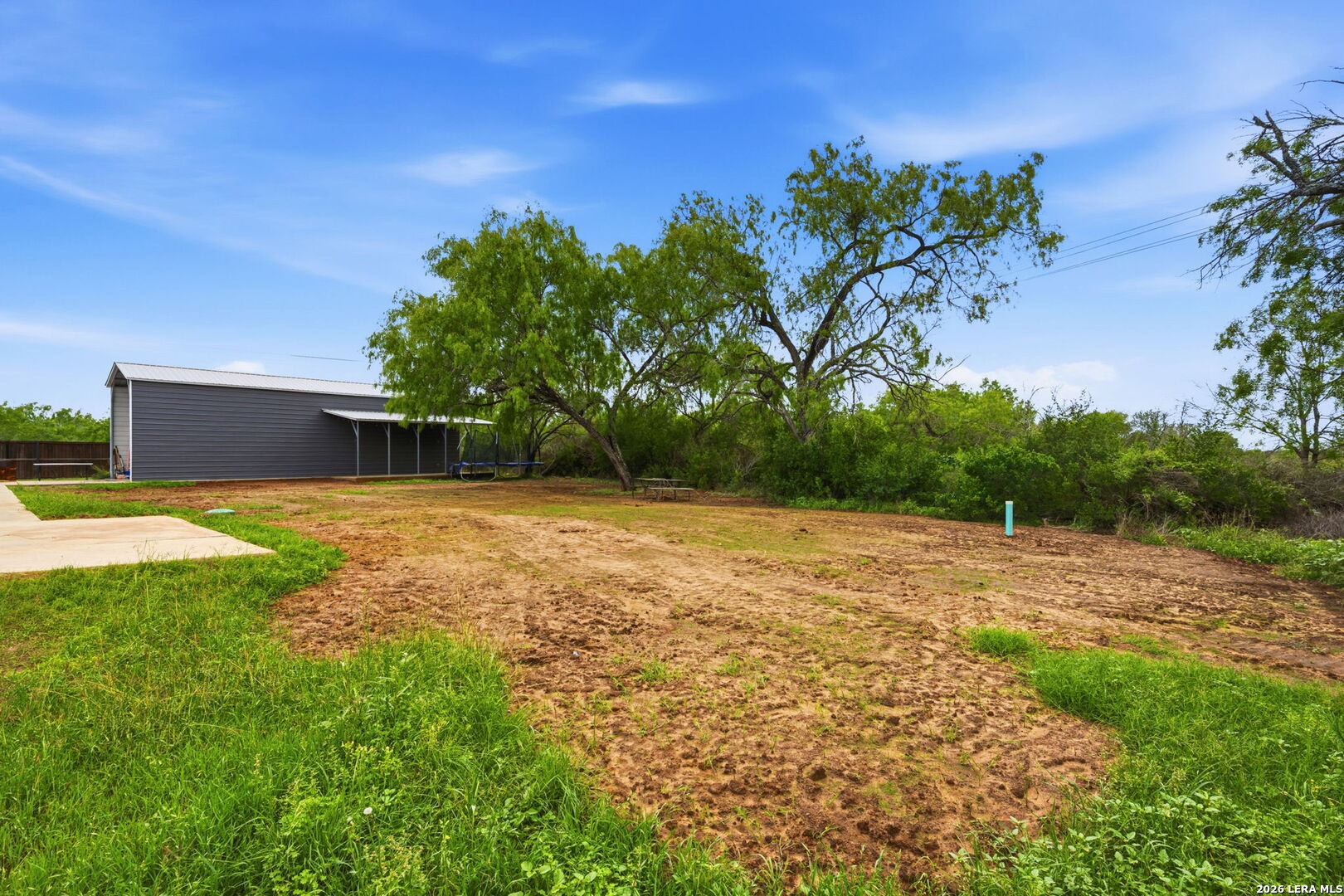 202 Bryan Drive Jourdanton, TX 78026 - Photo 26 of 28 a view of a backyard