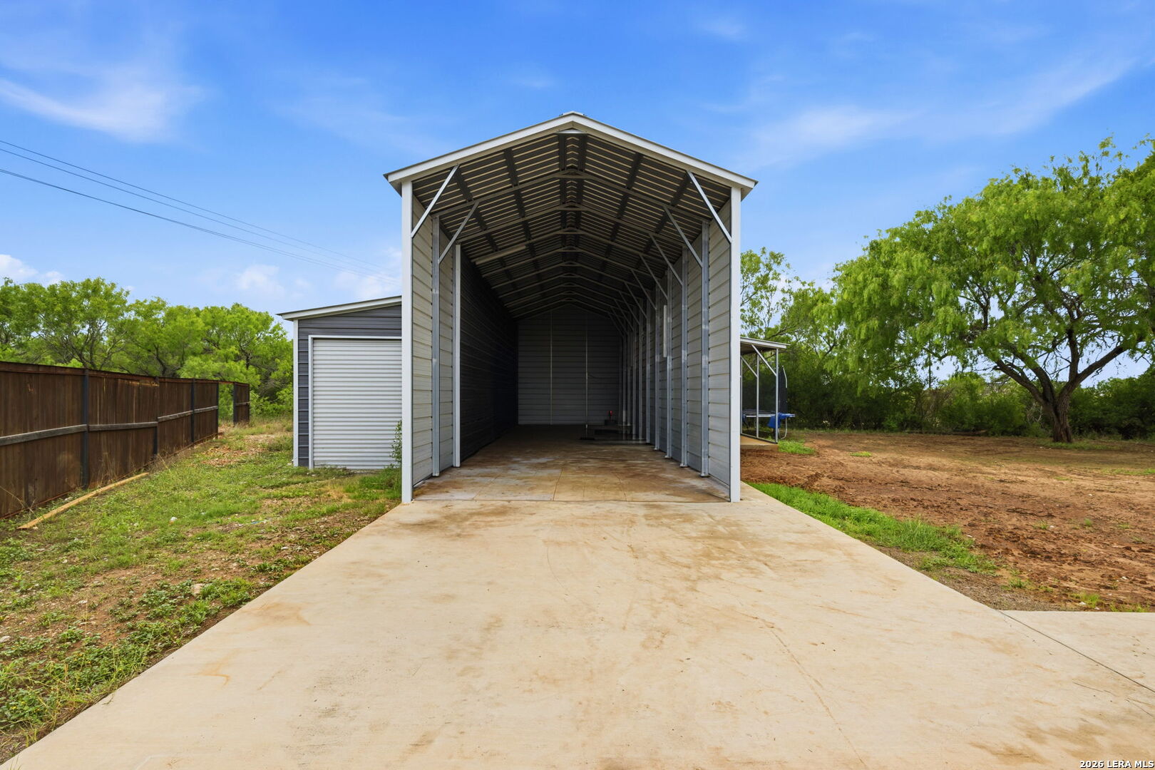 202 Bryan Drive Jourdanton, TX 78026 - Photo 28 of 28 a view of a wooden door and a yard