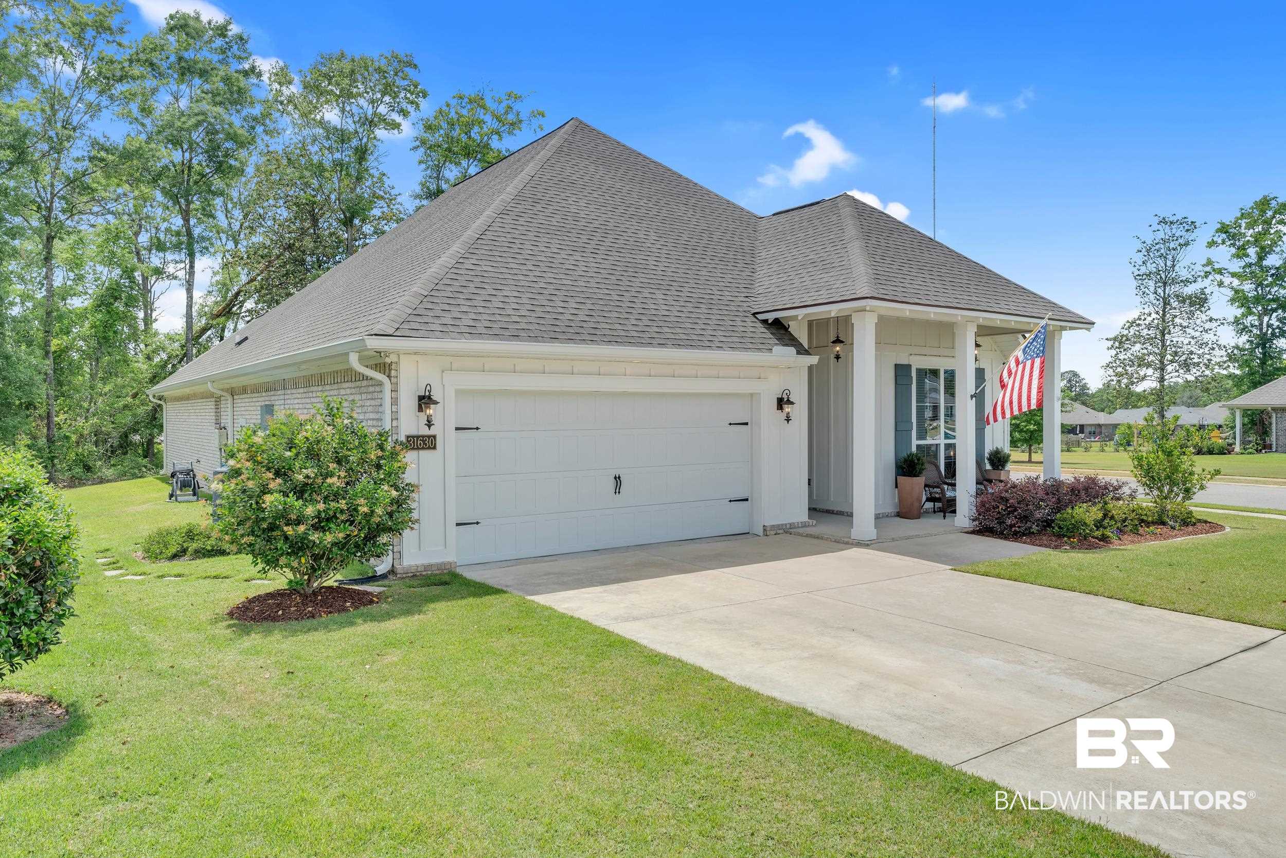 31630 Canopy Loop Daphne, AL 36527 - Photo 2 of 30 View of front of house with concrete driveway, a front yard, an attached garage, and roof with shingles