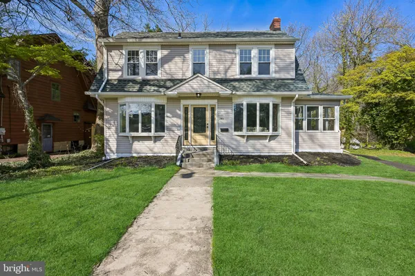 a front view of a house with a yard table and chairs