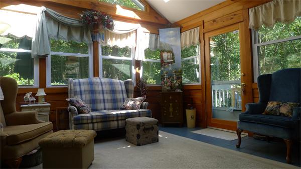 20 Willow Road Boxford, MA 01921 - Photo 13 of 15 a living room with furniture a flat screen tv and a floor to ceiling window