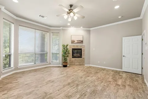 a view of an empty room with a fireplace and a window