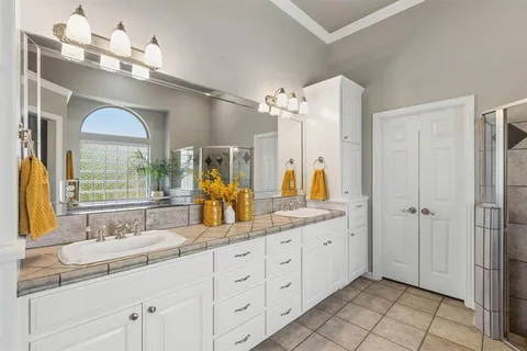 a spacious bathroom with a double vanity sink mirror and