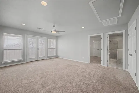 an empty room with windows and closet
