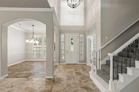 a view of an entryway with wooden floor