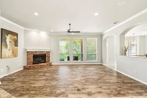 a view of an empty room with window and fire place