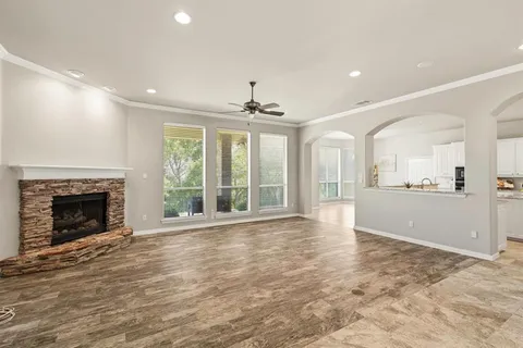 a view of an empty room with a fireplace and a window