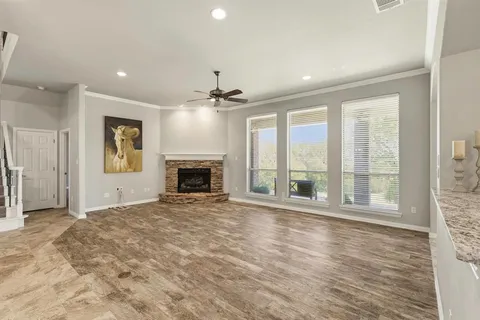 a view of an empty room with a window and a fireplace