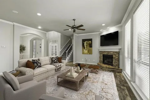 a living room with furniture a fireplace and a flat screen tv