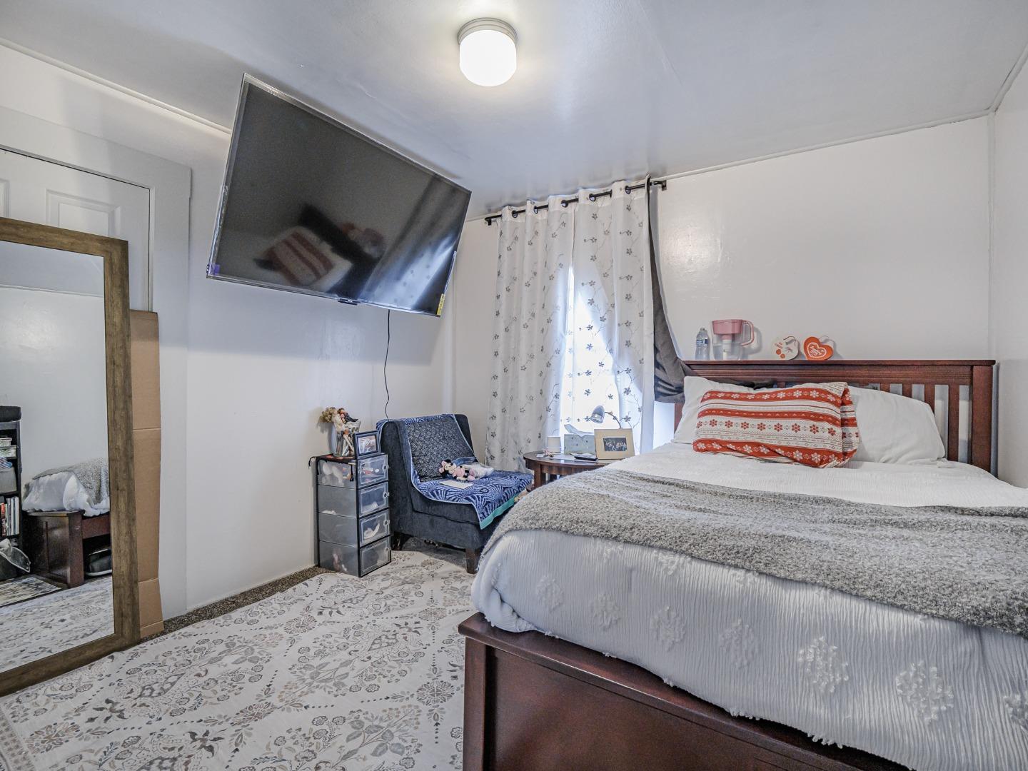 140 East Riverside Drive Watsonville, CA 95076 - Photo 11 of 49 a bedroom with a bed and a flat screen tv