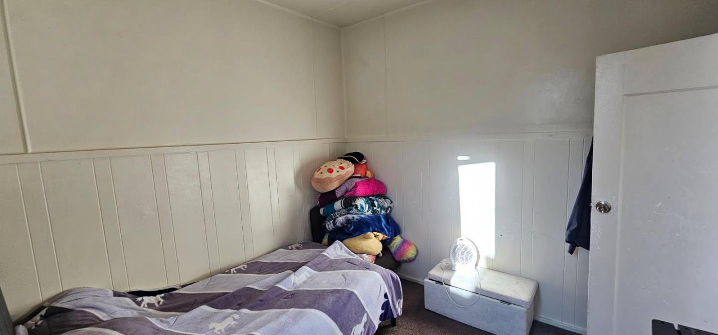 140 East Riverside Drive Watsonville, CA 95076 - Photo 27 of 49 a bedroom with a bed and a chandelier