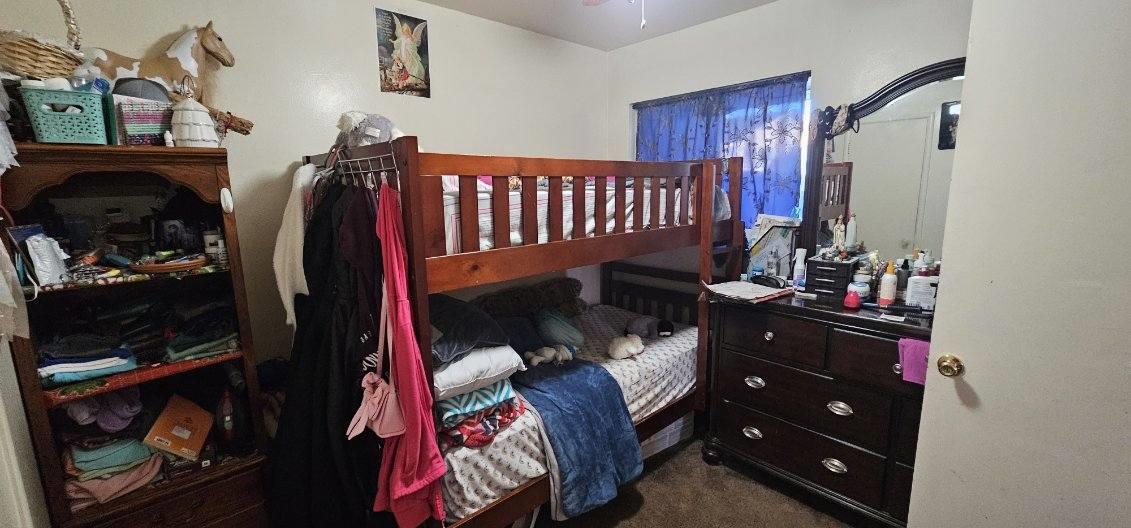 140 East Riverside Drive Watsonville, CA 95076 - Photo 46 of 49 a bedroom with a bed closet and flat tv screen