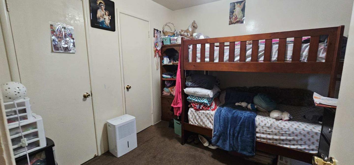 140 East Riverside Drive Watsonville, CA 95076 - Photo 47 of 49 a living room with furniture a baby crib and a wooden floor