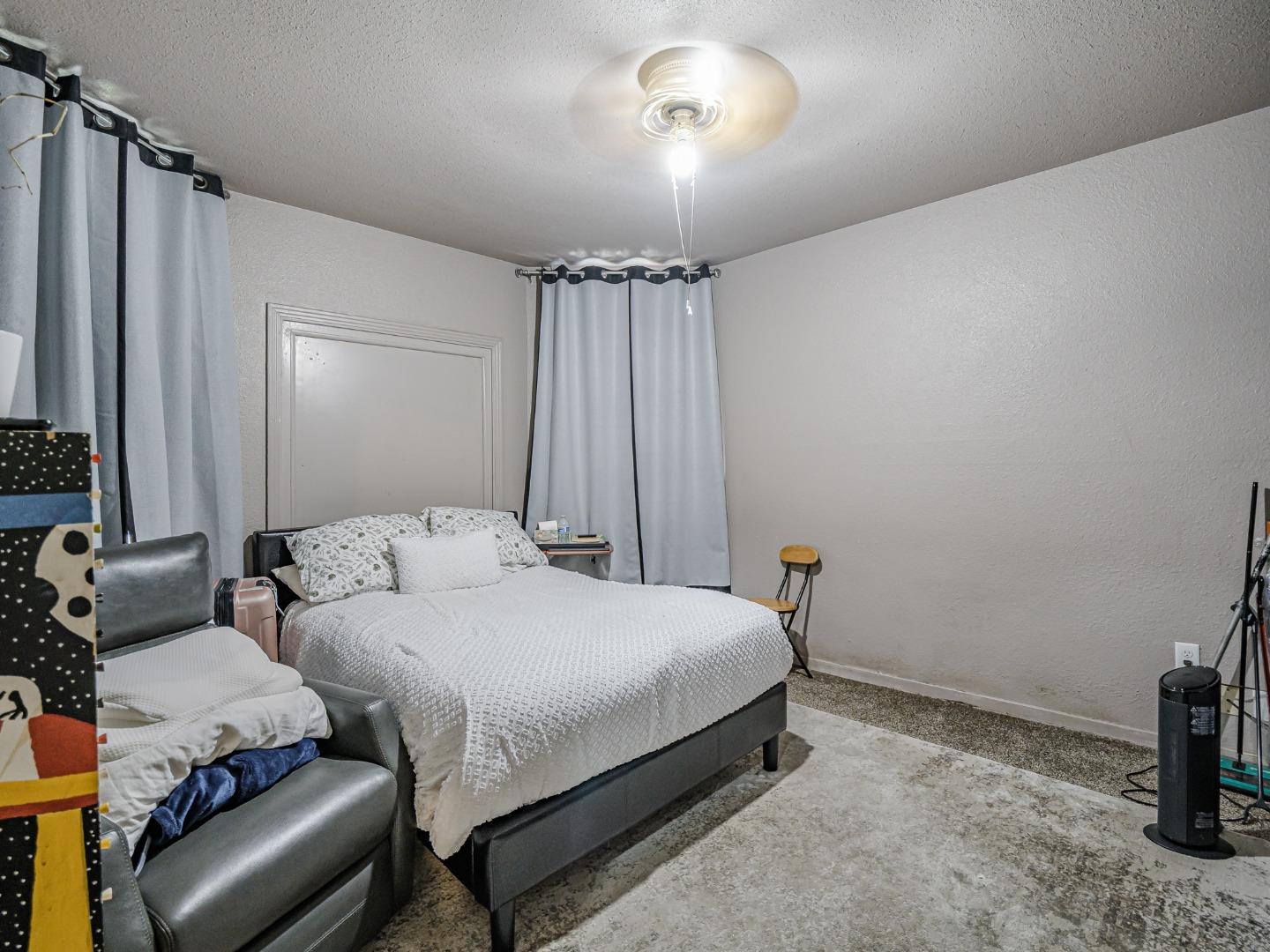 140 East Riverside Drive Watsonville, CA 95076 - Photo 10 of 49 a bedroom with a bed and a chandelier