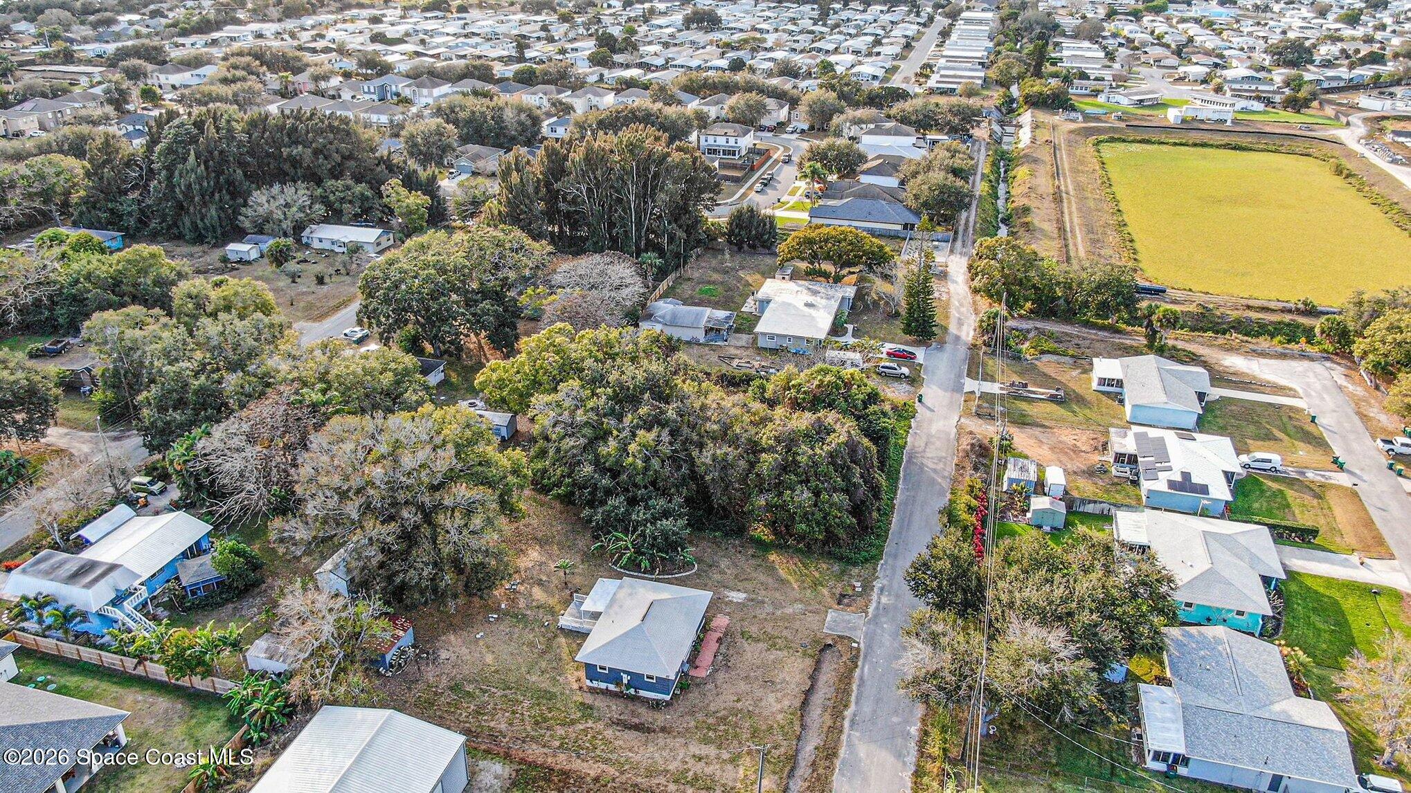 0 Unknown Street Melbourne, FL 32904 - Photo 13 of 16 an aerial view of residential houses with outdoor space