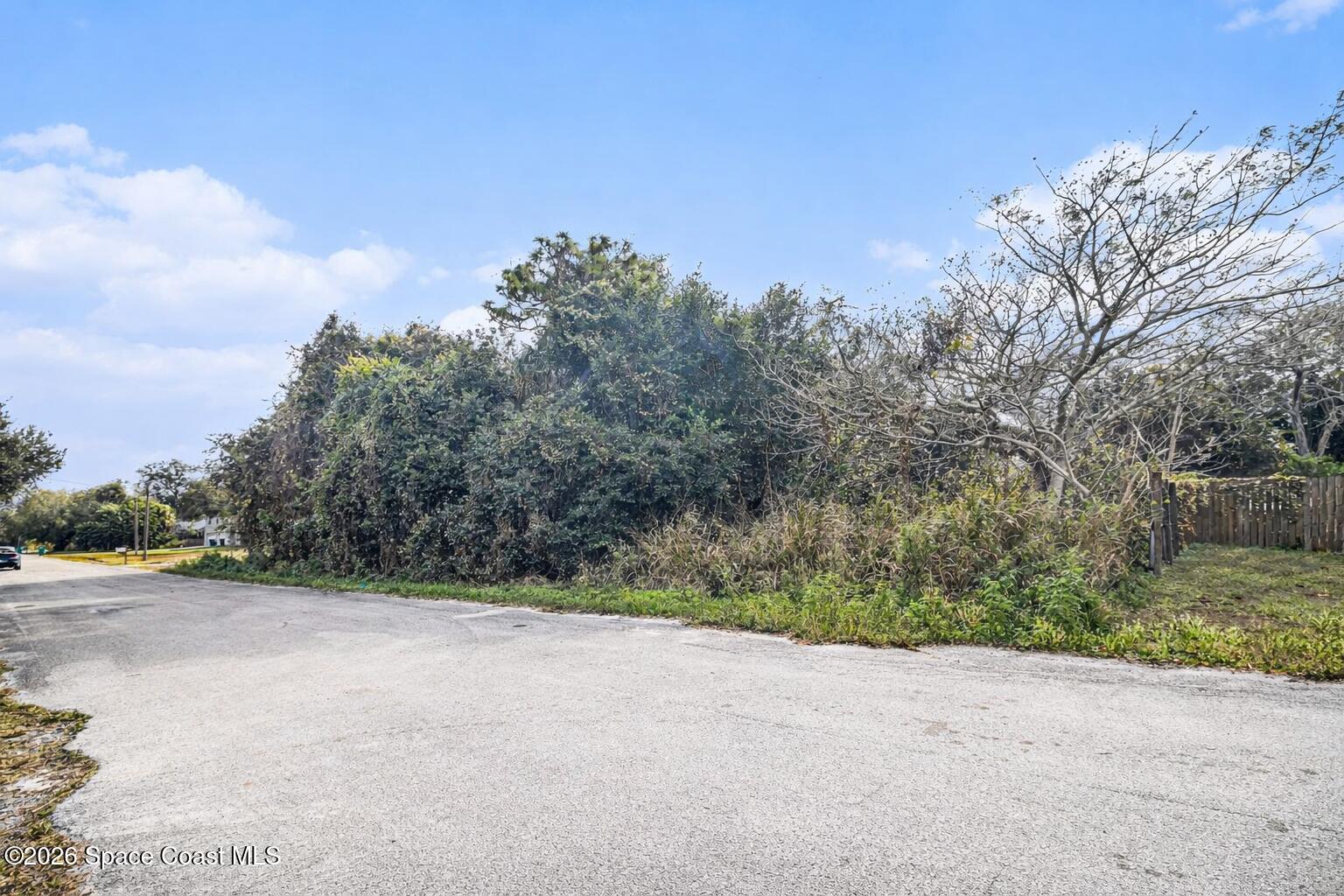 0 Unknown Street Melbourne, FL 32904 - Photo 2 of 16 a view of a road with a building in the background