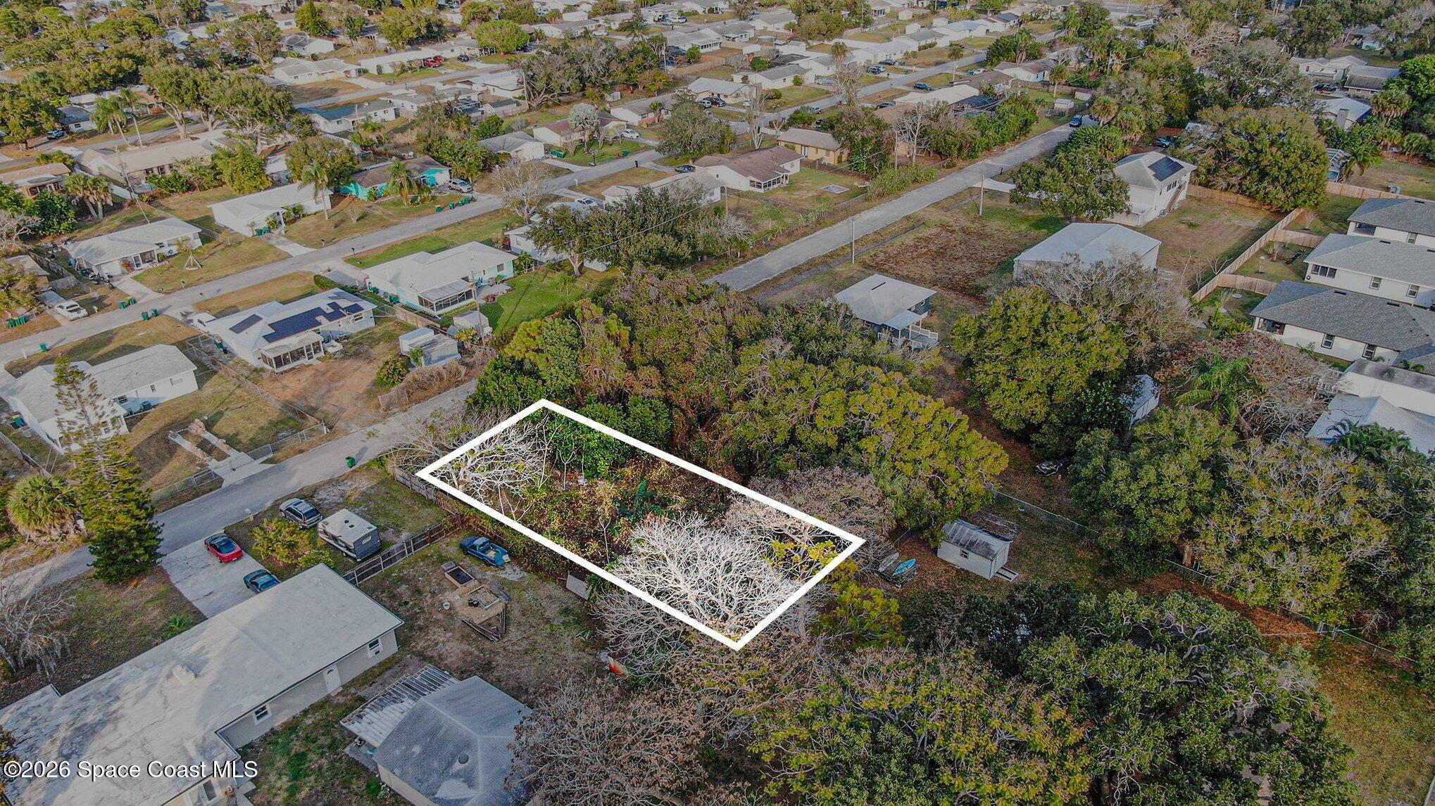 0 Unknown Street Melbourne, FL 32904 - Photo 8 of 16 an aerial view of a house with a yard